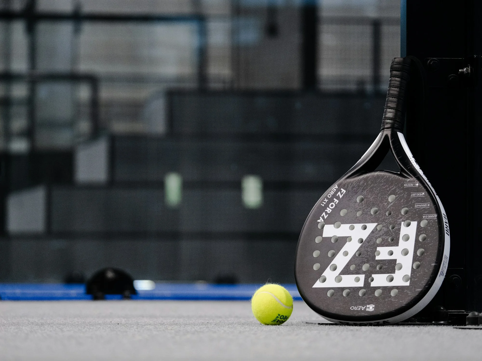 Raquette et balle de padel sur un terrain — photo d’illustration